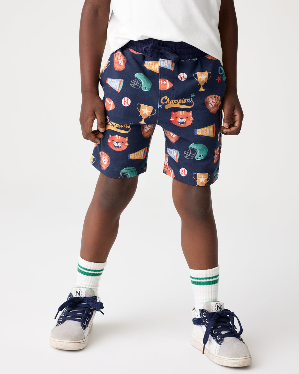 Boy wearing the Team Spirit Drawstring Shorts with sneakers