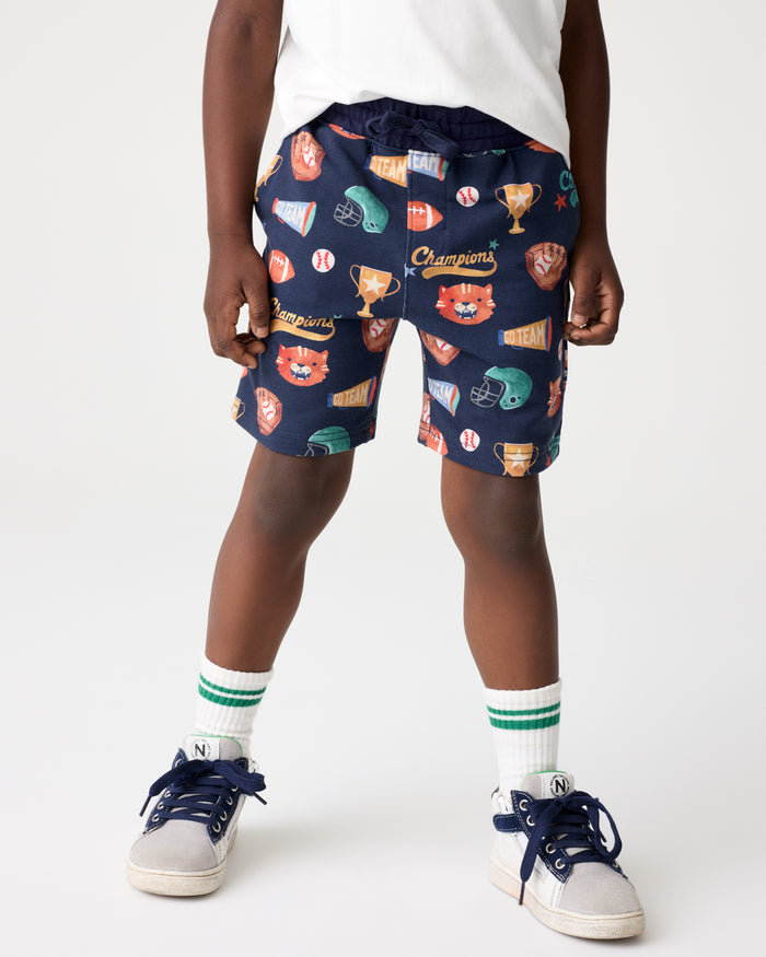Boy wearing the Team Spirit Drawstring Shorts with sneakers