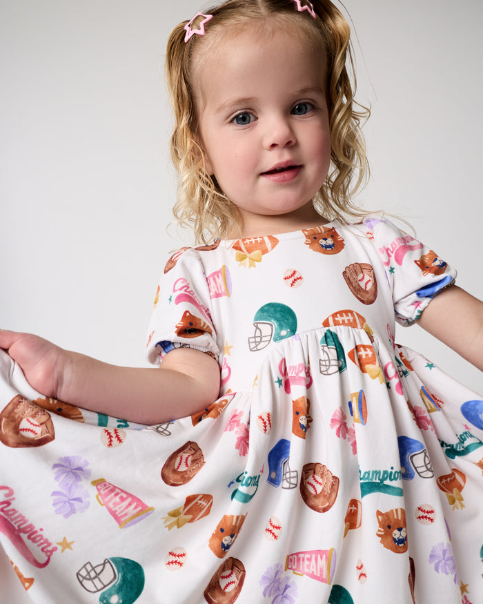 Girl wearing the Team Spirit Babydoll Dress