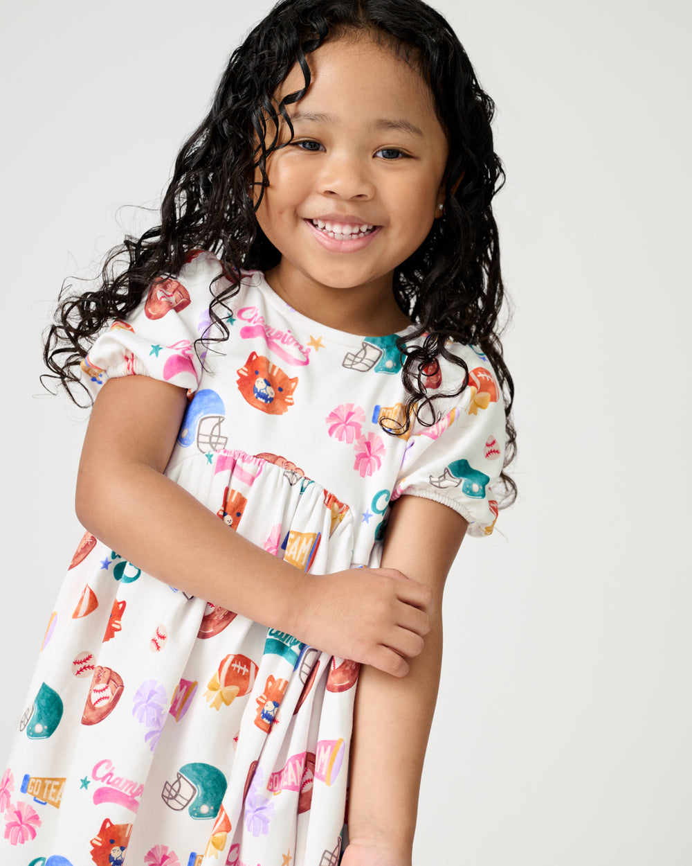Close up of girl wearing the Team Spirit Babydoll Dress
