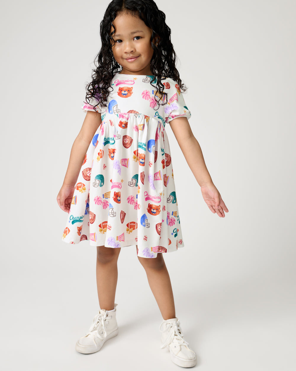 Girl wearing the Team Spirit Babydoll Dress with sneakers