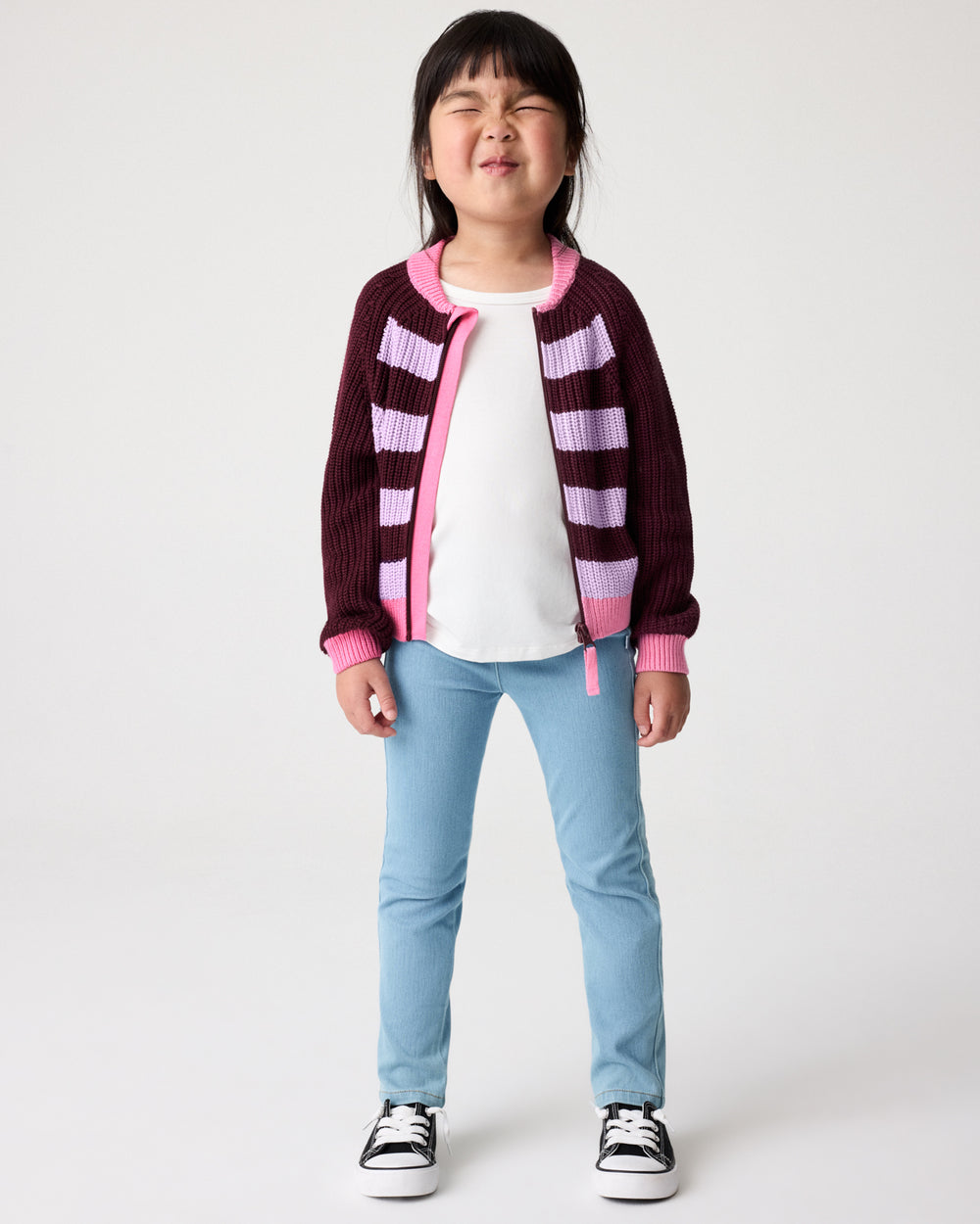 Girl wearing the Powder Lilac Stripe Bomber Jacket layered over a white tee