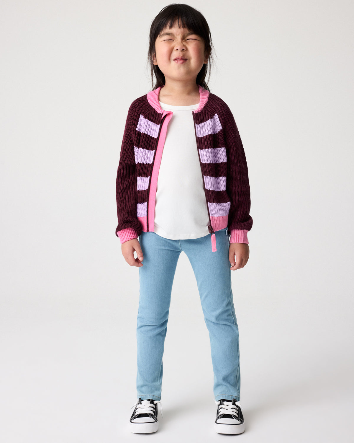 Girl wearing the Powder Lilac Stripe Bomber Jacket layered over a white tee