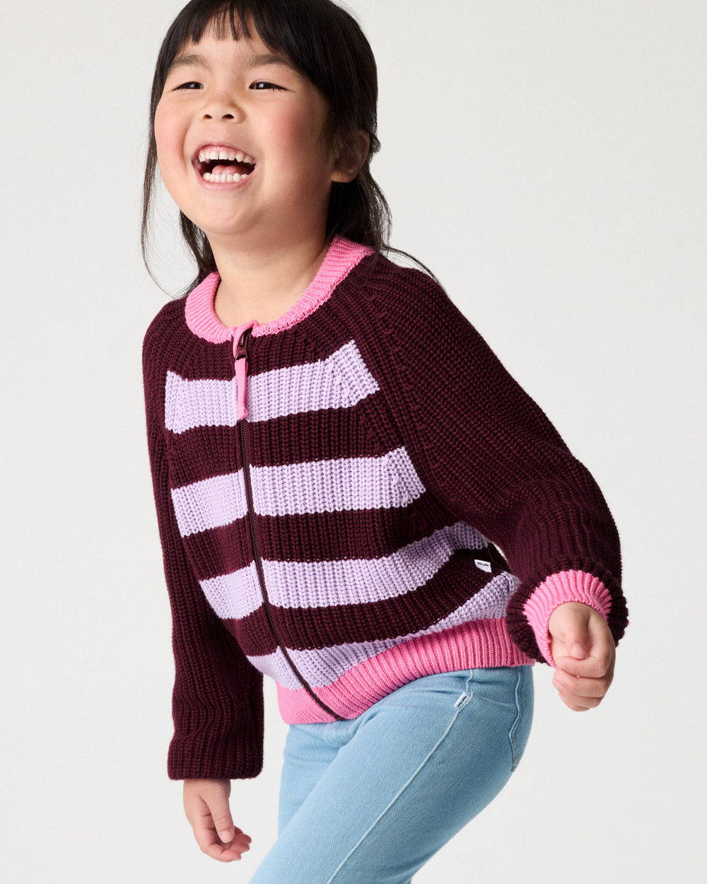 Child wearing the Powder Lilac Stripe Bomber Jacket with denim pants