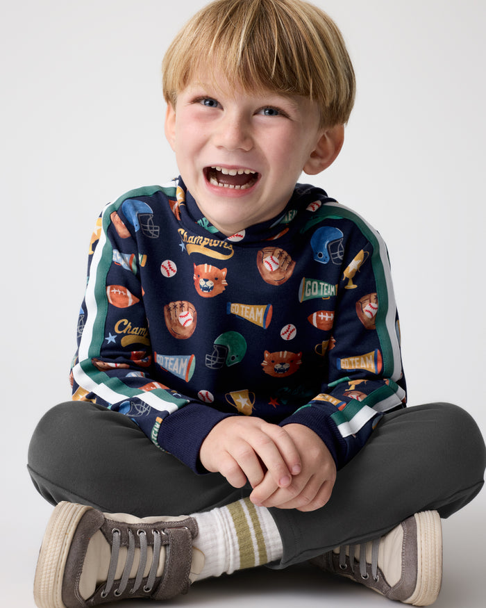 Sitting boy wearing the Team Spirit Pullover Hoodie