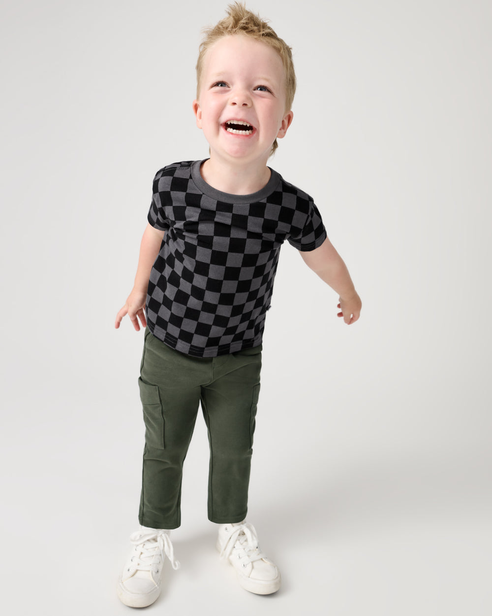 Boy wearing the Desert Moss Cargo Pants and Monochrome Checks tee