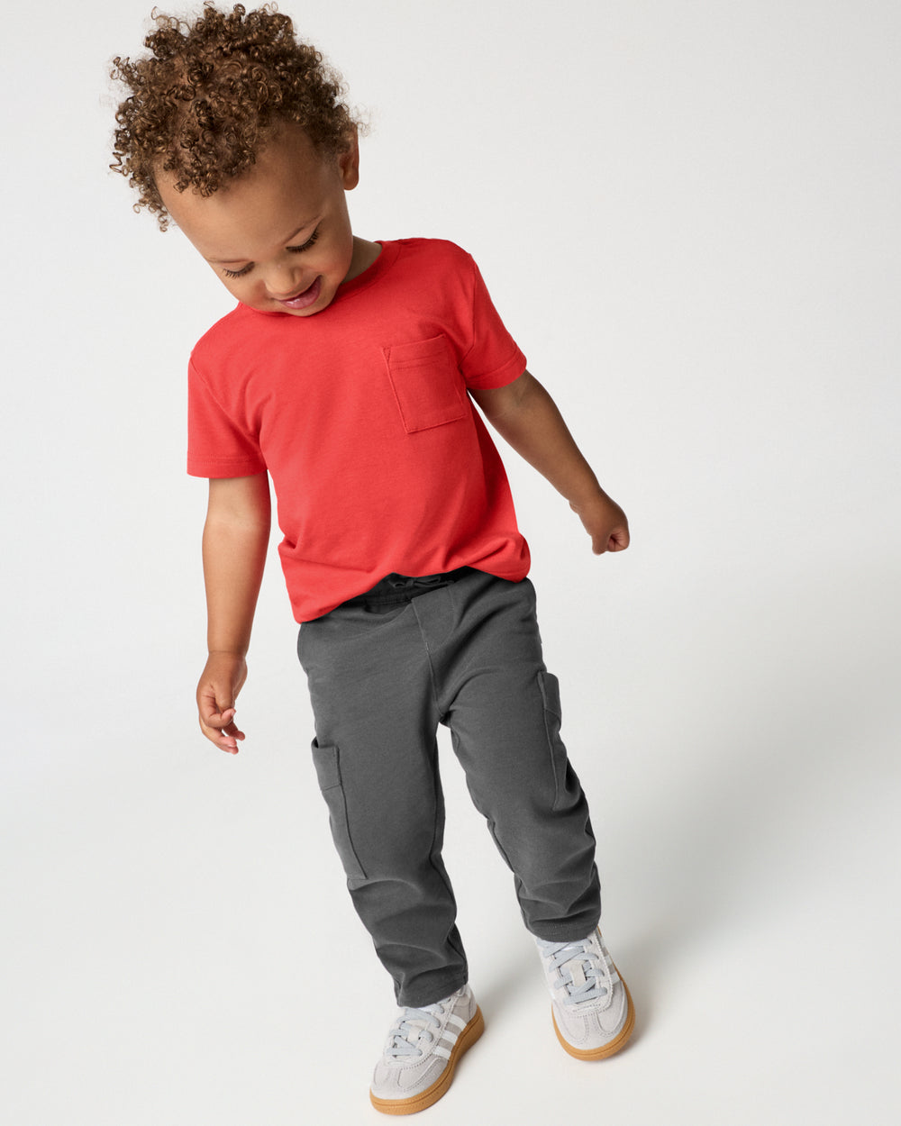Alternate boy wearing the Washed Black Cargo Pants with a Red Pocket Tee