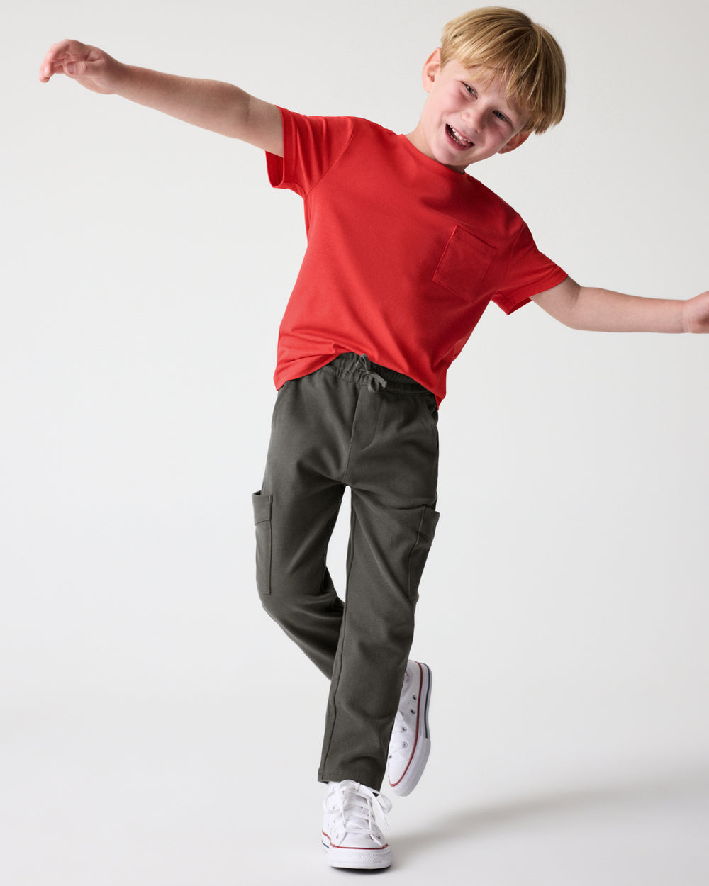 Boy wearing the Washed Black Cargo Pants with a red tee
