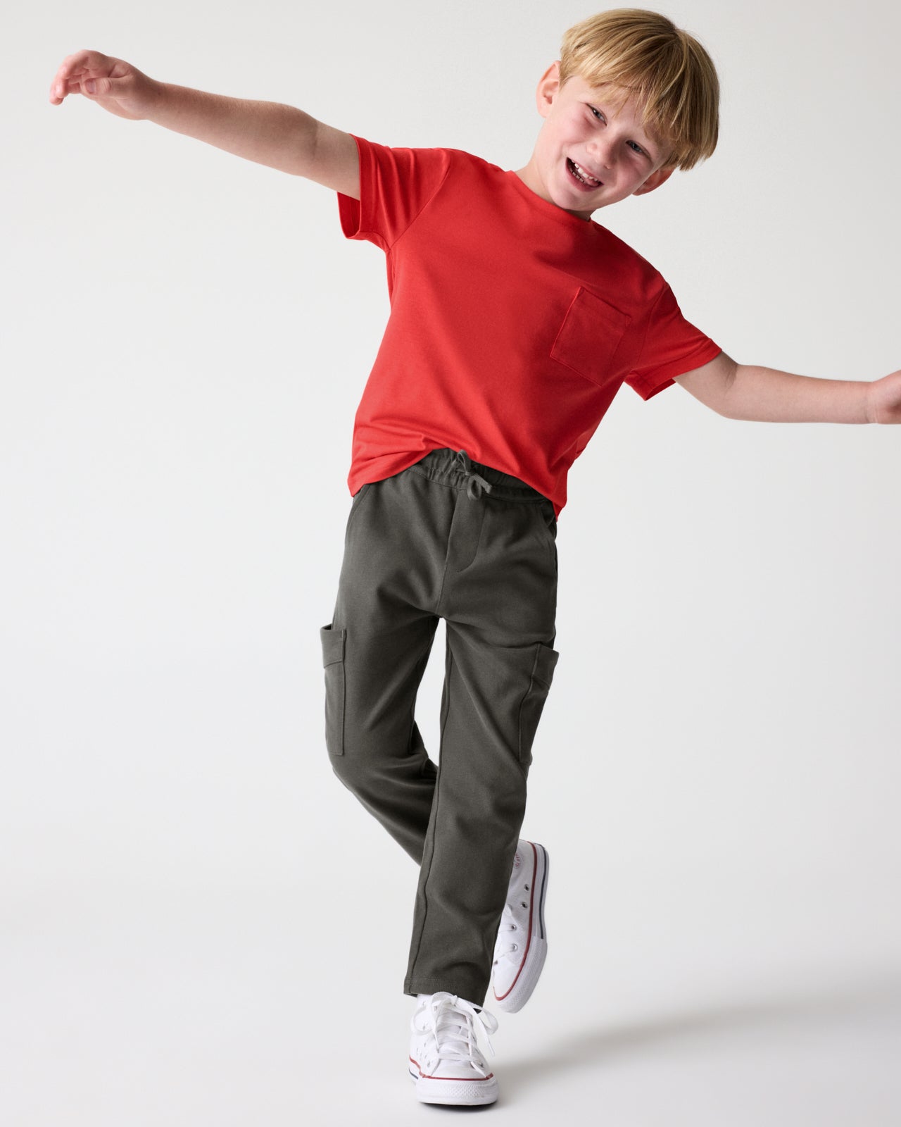Boy wearing the Washed Black Cargo Pants with a red tee