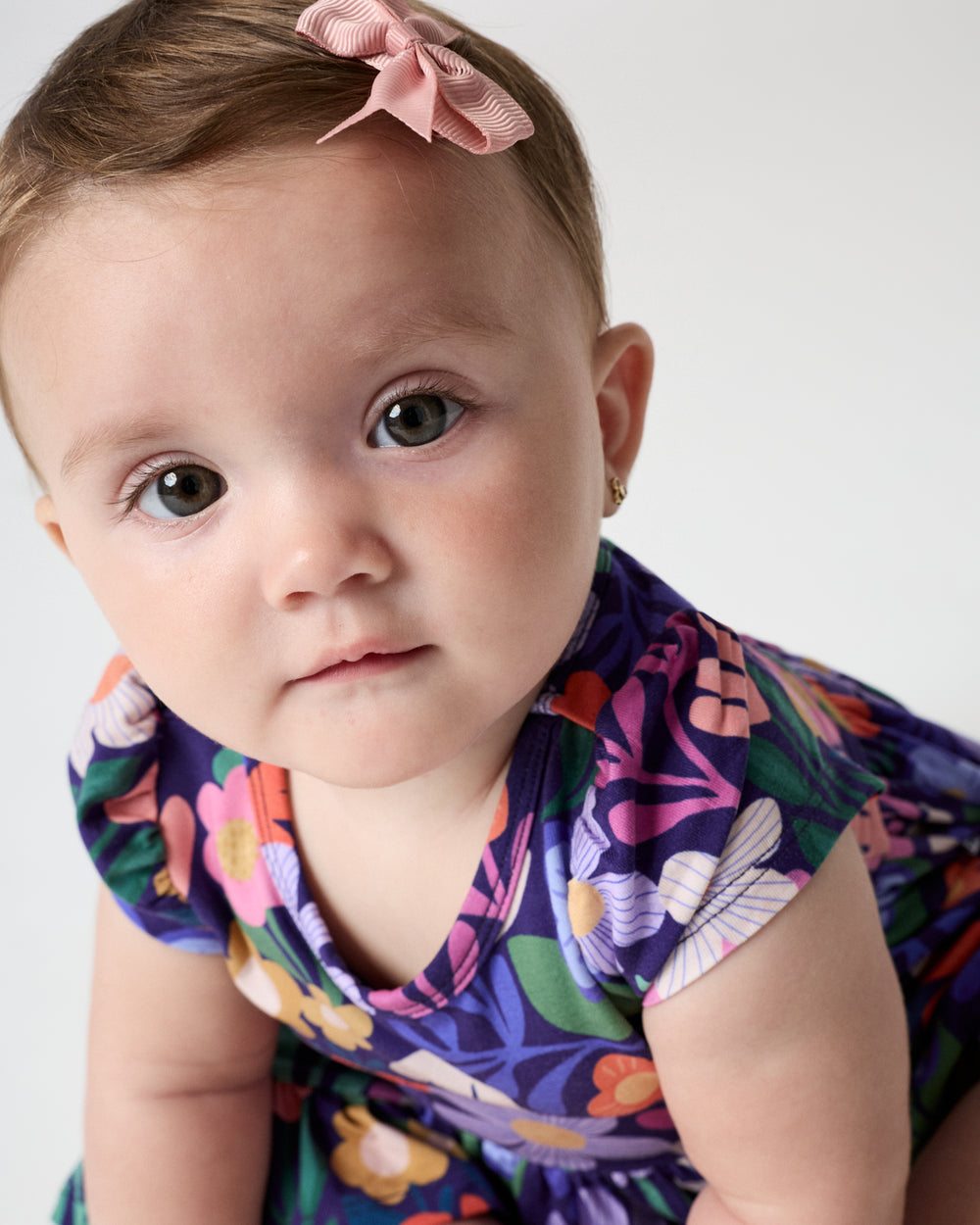 Close up of baby wearing the Wild Garden Ruffle Twirl Dress with Bodysuit