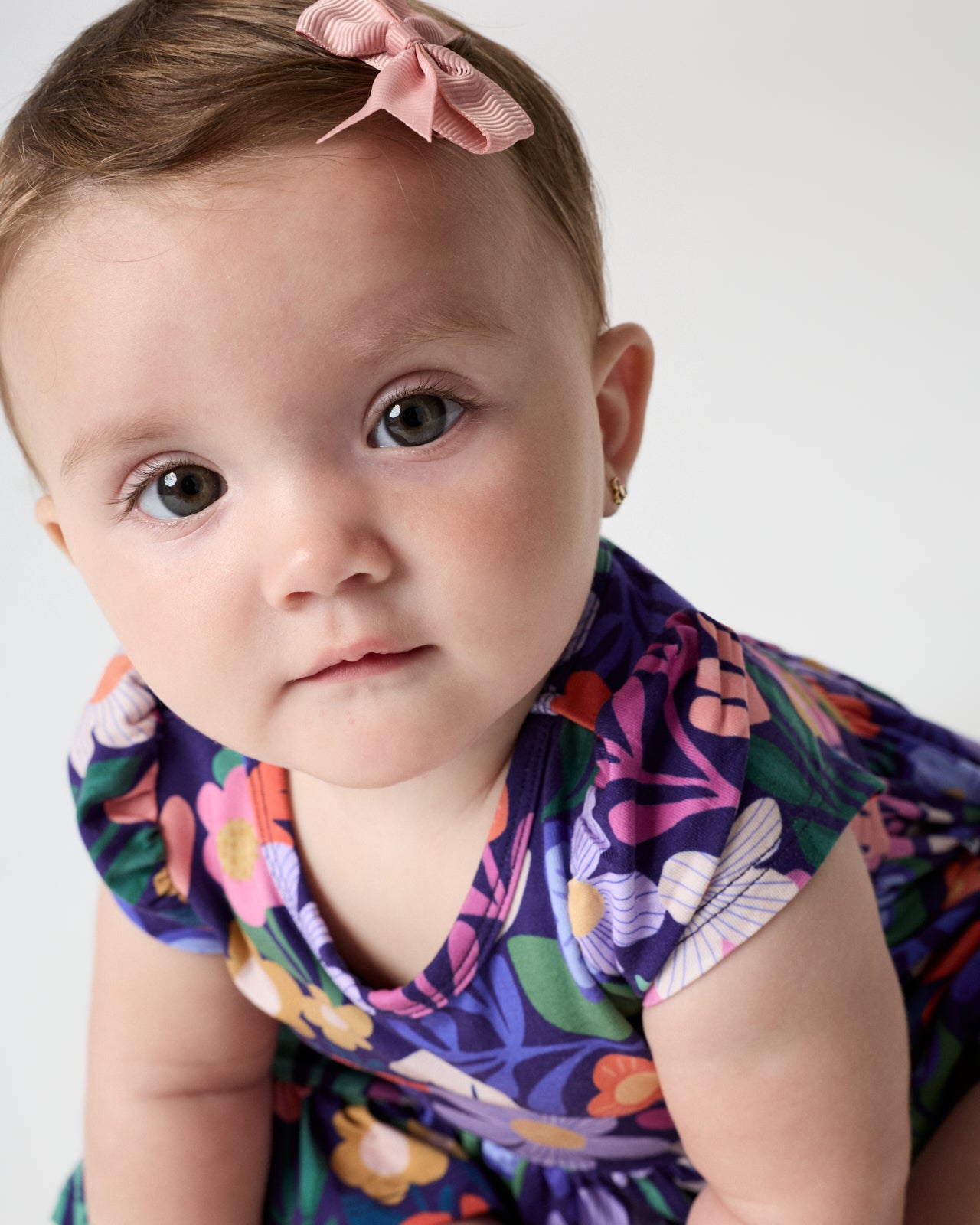 Close up of baby wearing the Wild Garden Ruffle Twirl Dress with Bodysuit