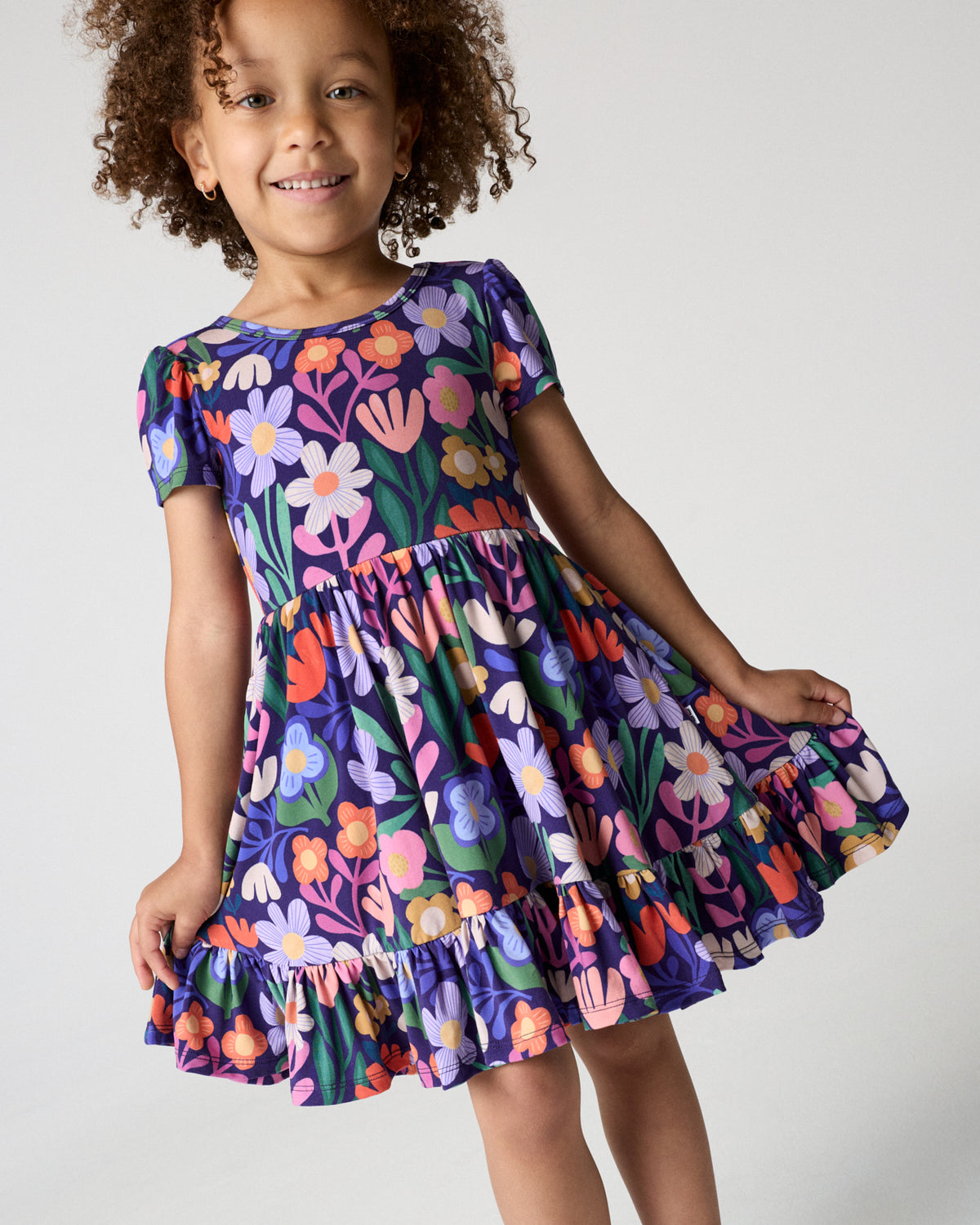 Close up of girl wearing the Wild Garden Ruffle Twirl Dress