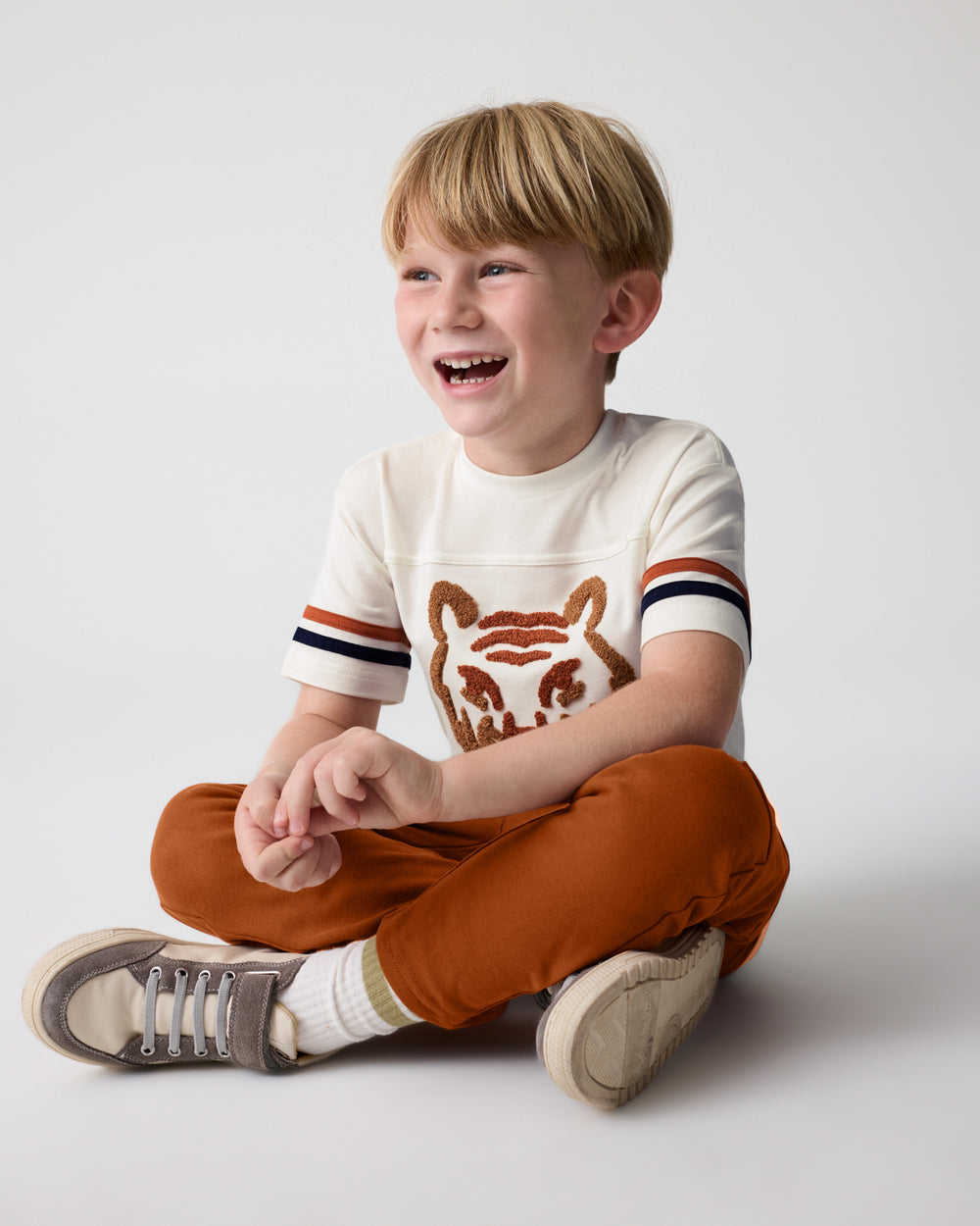 Sitting boy wearing the Amber Oak Cargo Pants