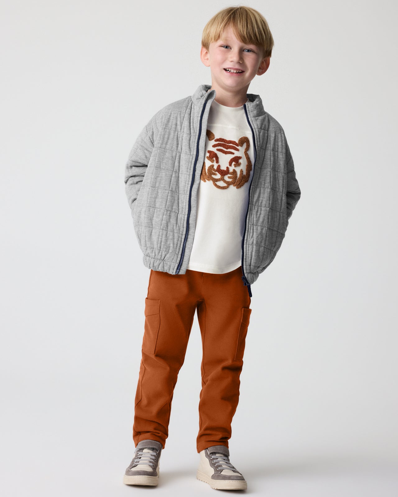Boy wearing the Amber Oak Cargo Pants with a gray jacket