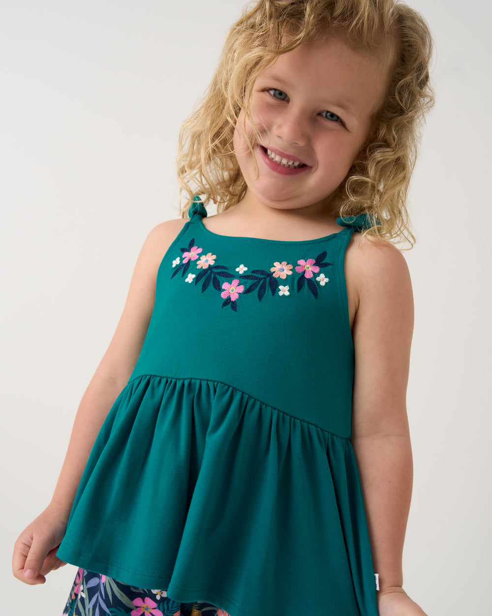 Girl wearing the Midnight Tide Embroidered Peplum Tank