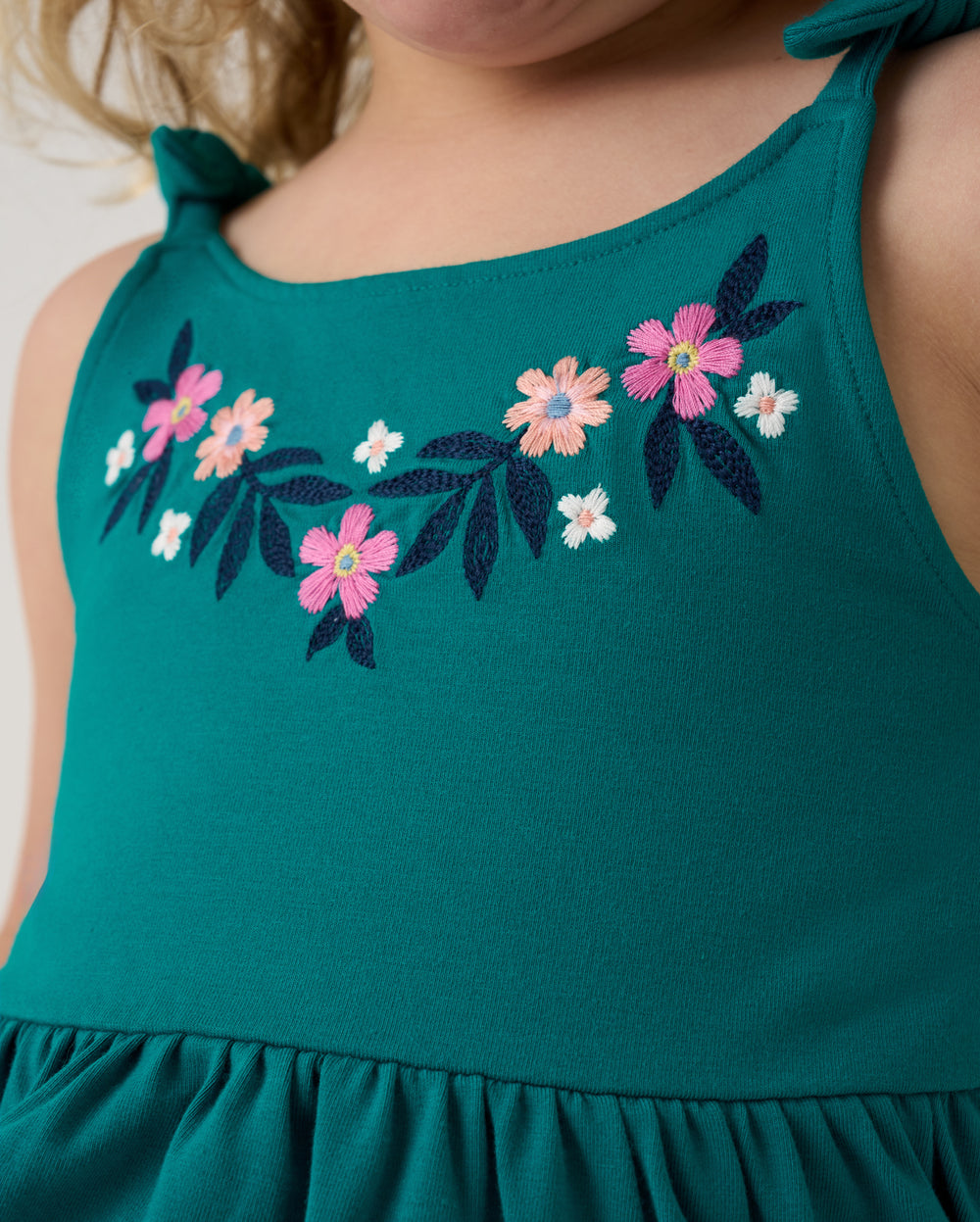 Close up of the embroidered detail on the Midnight Tide Embroidered Peplum Tank