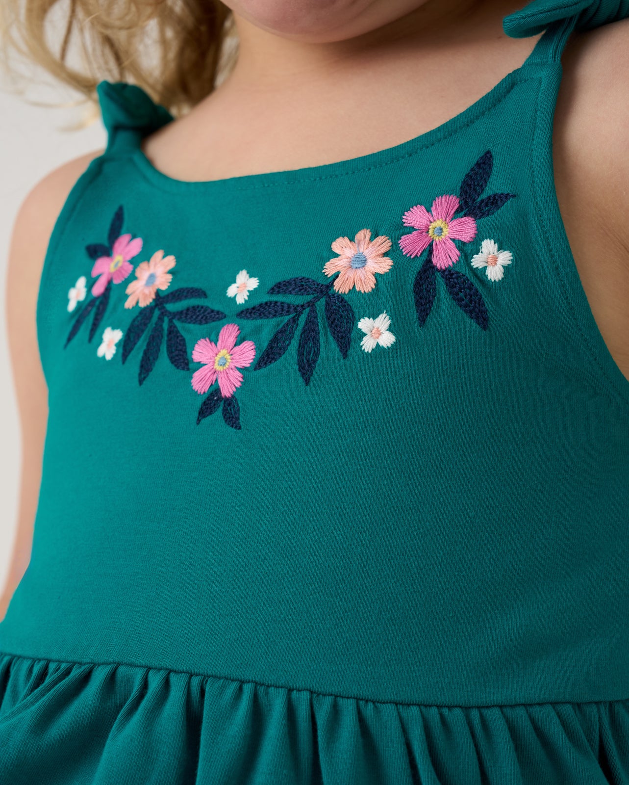Close up of the embroidered detail on the Midnight Tide Embroidered Peplum Tank