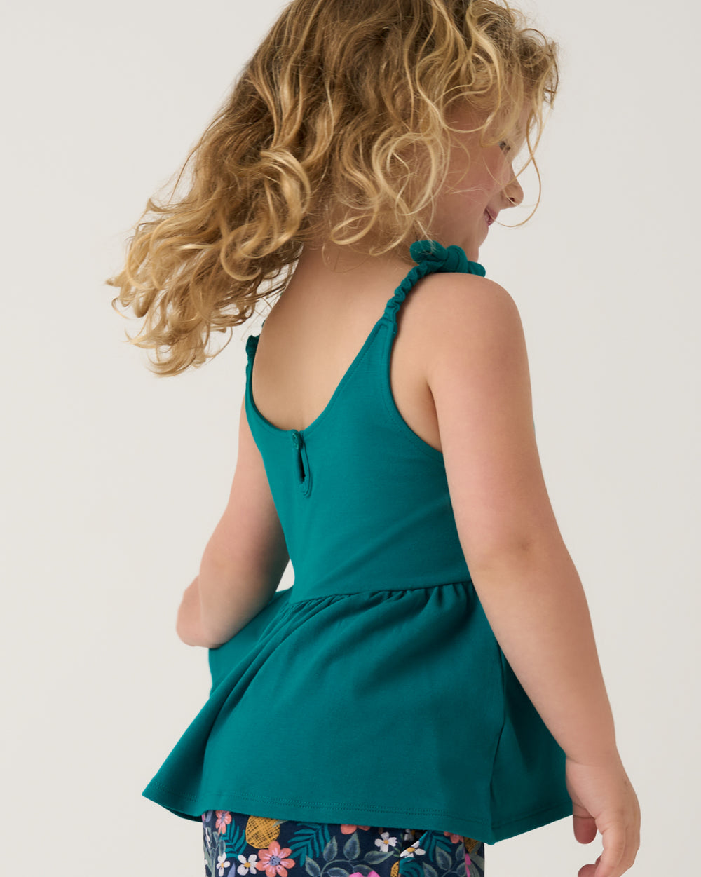Back view of child wearing the Midnight Tide Embroidered Peplum Tank