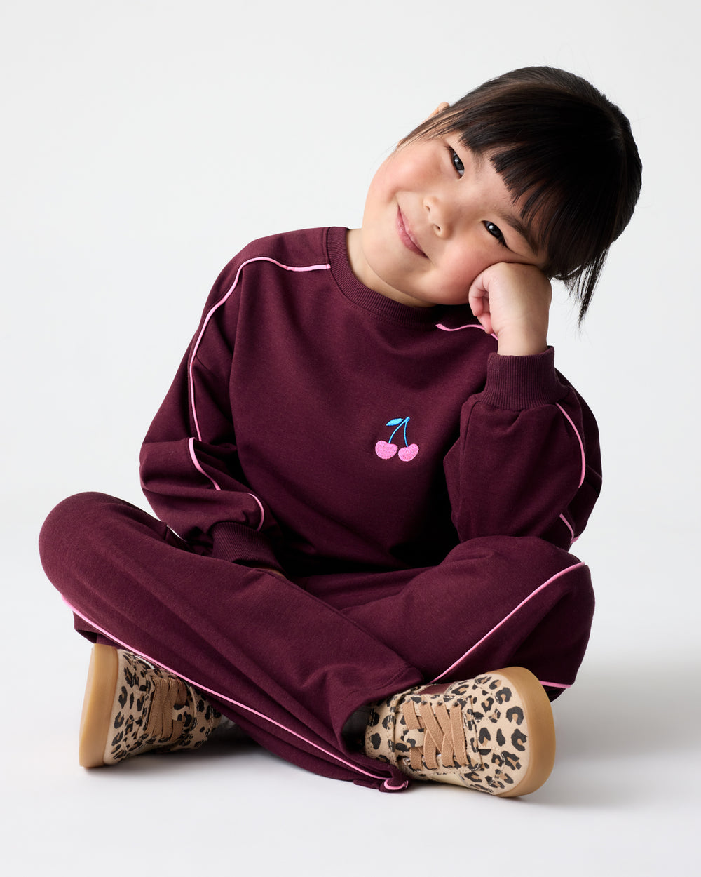 Girl wearing the Classic Burgundy Drop Shoulder Crewneck and Wide Leg pants