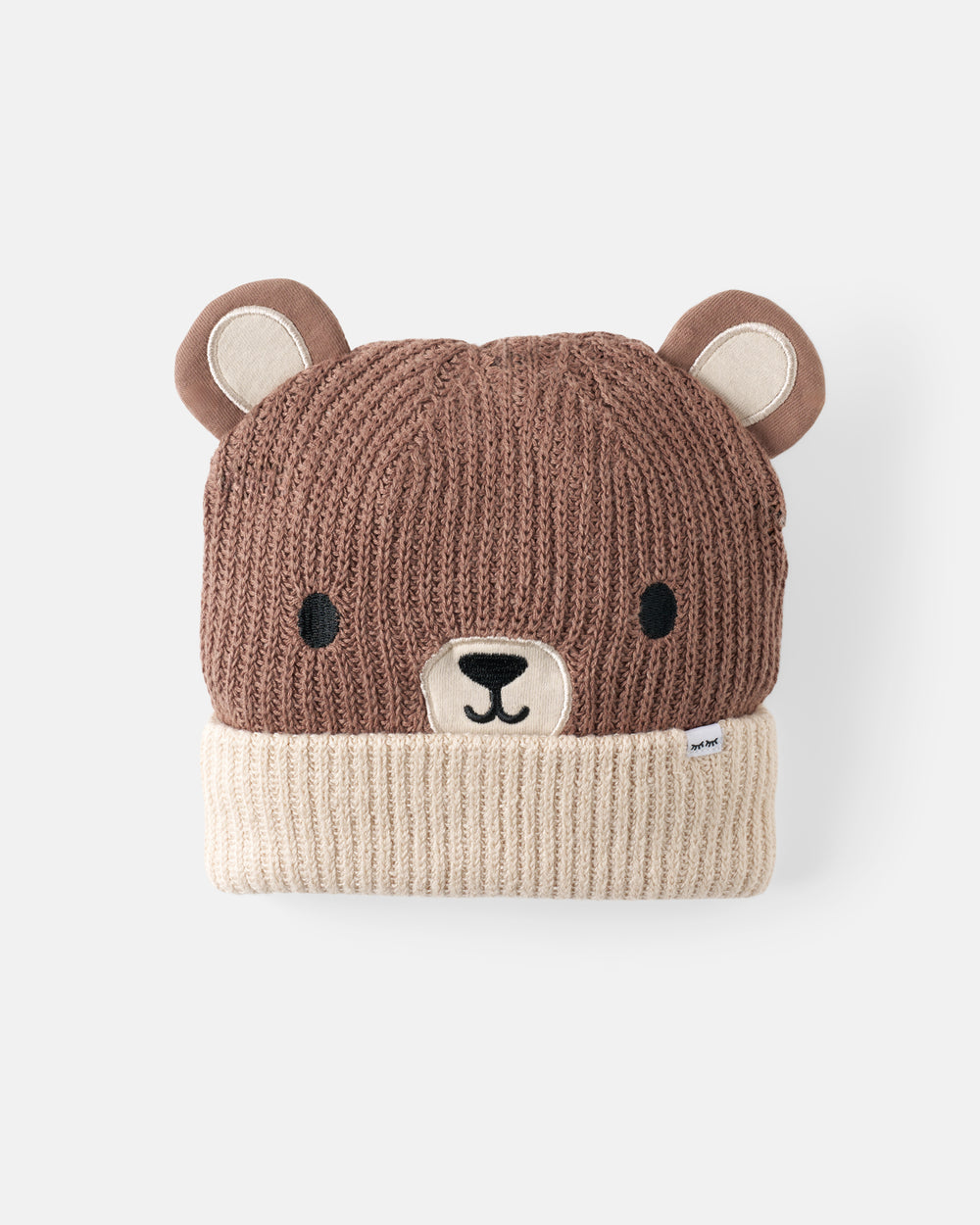 A brown and cream knit bear-face beanie hat on a light gray background.