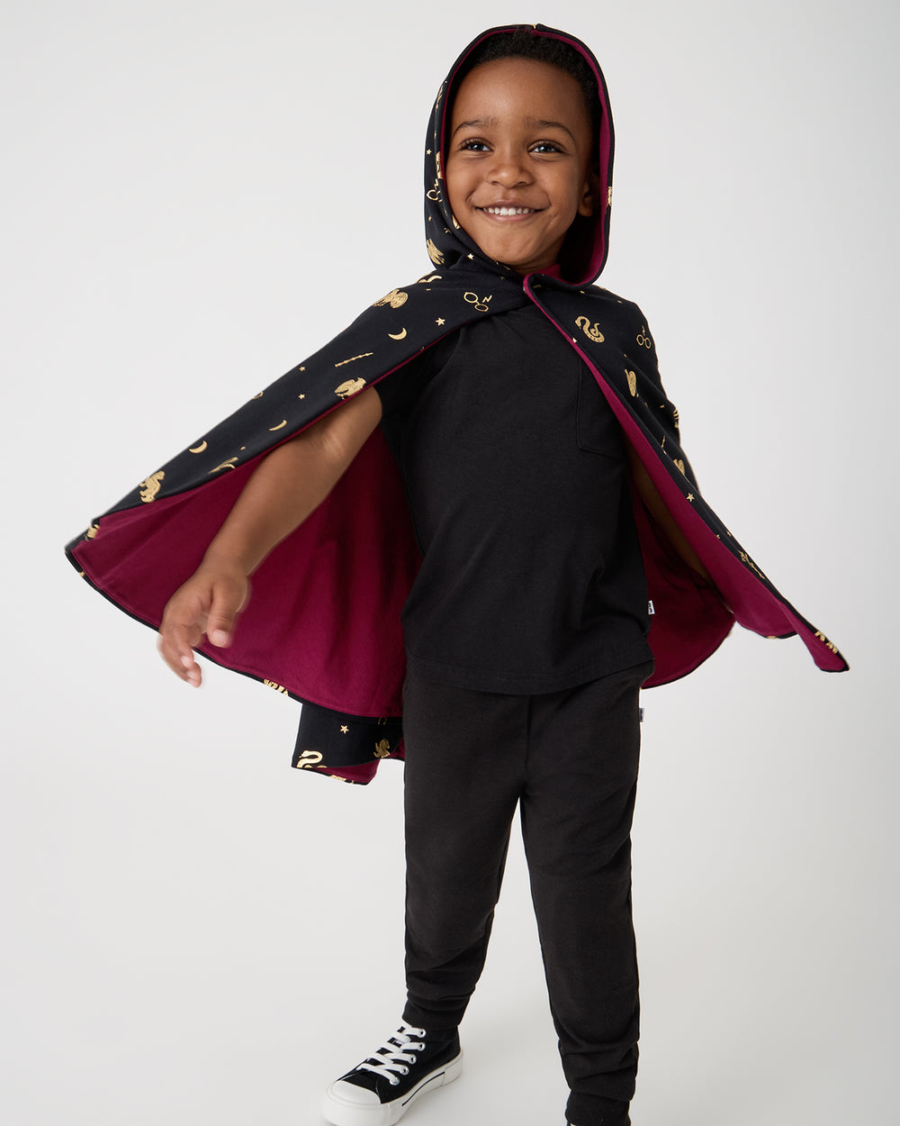 Boy wearing the Harry Potter™ Spellbinding Studies Hooded Cloak over a black tee