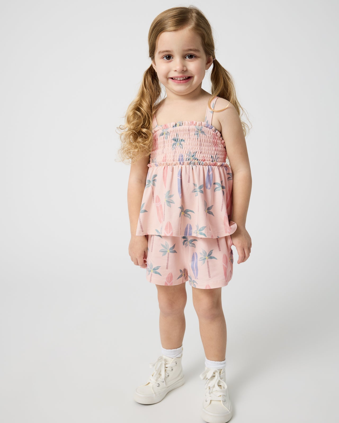 Standing girl wearing the Palm Dunes Smocked Tank & Shorts Set