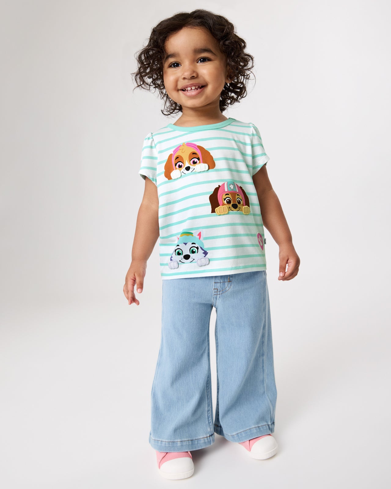 Girl wearing the PAW Patrol Rescue Ready Puff Sleeve Tee with denim pants