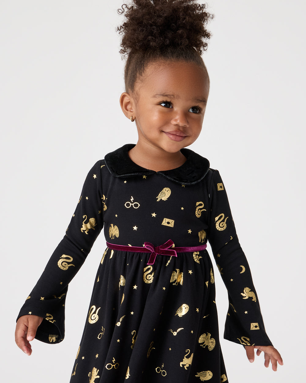 Close up of girl wearing the Harry Potter™ Spellbinding Studies Flare Sleeve Twirl Dress