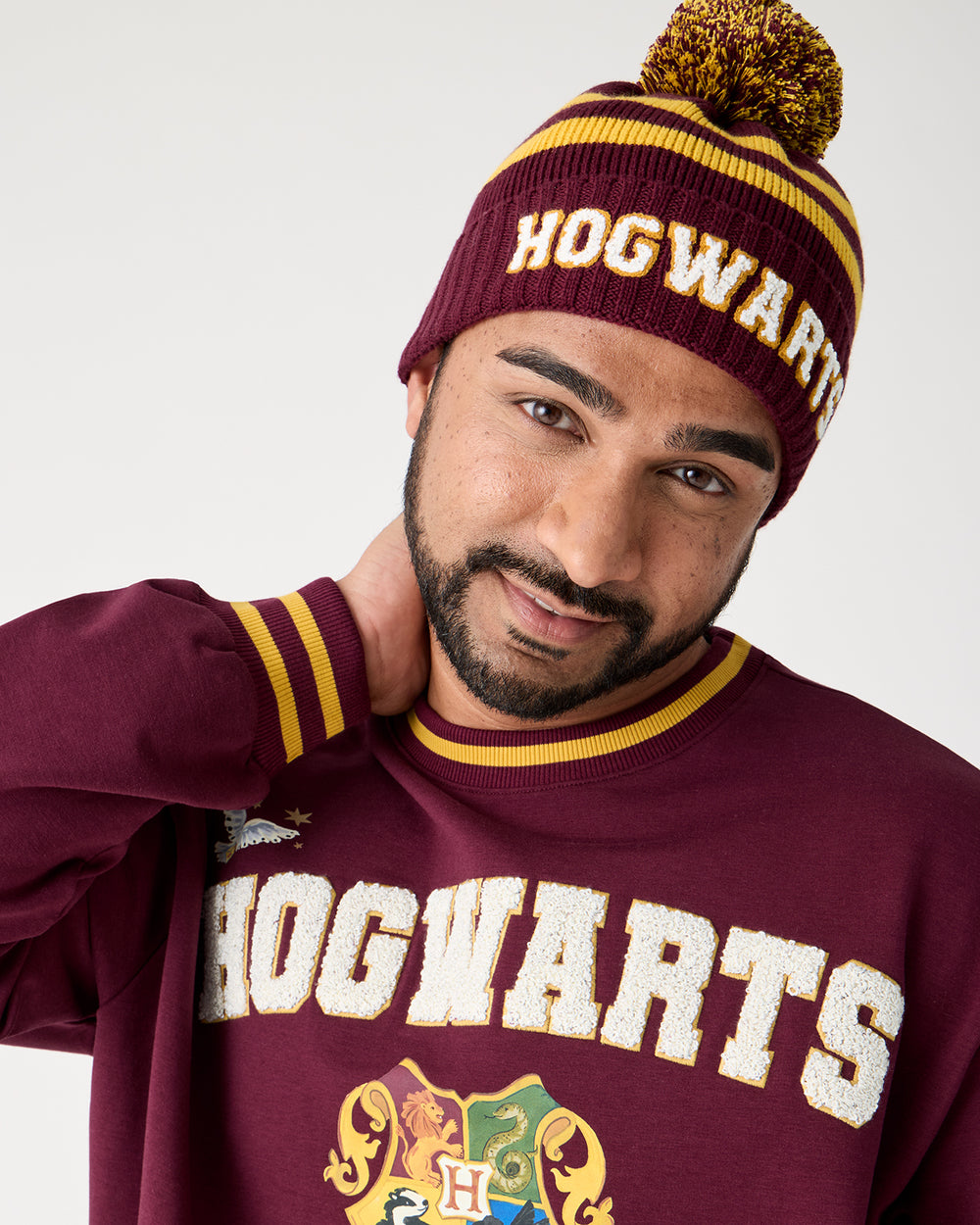 Close up of man wearing the Harry Potter™ Spellbinding Studies Adult Sweater Beanie