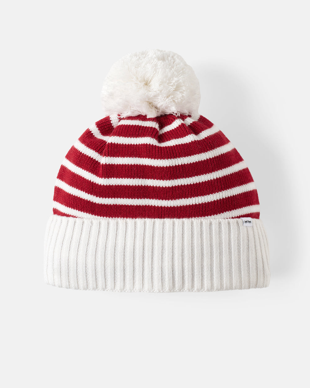 A red and white striped knit beanie with a fluffy white pom-pom on top and a ribbed white cuff, photographed against a clean white background.