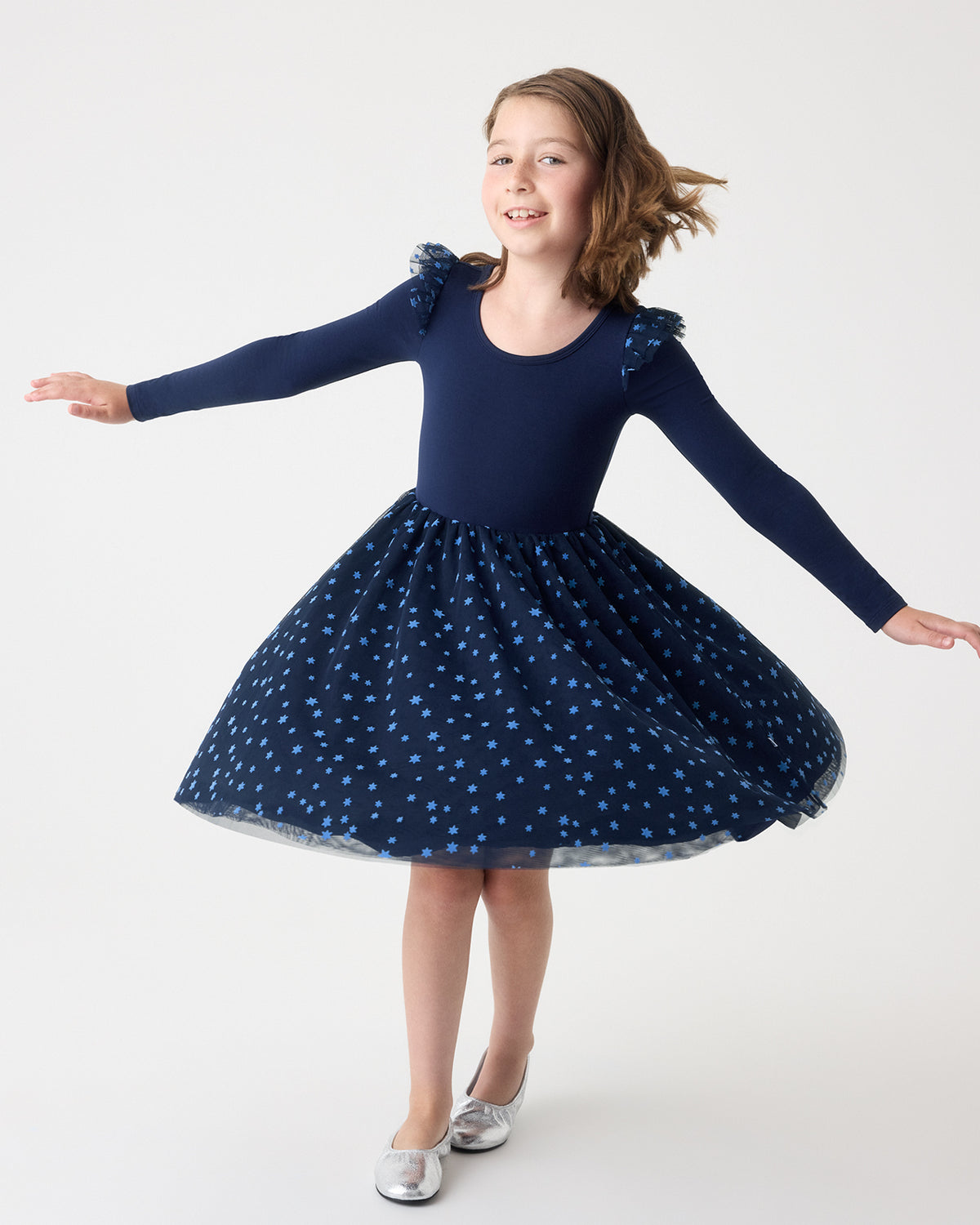 Twirling girl wearing the Hanukkah Night Sky Flutter Tutu Dress with silver flats