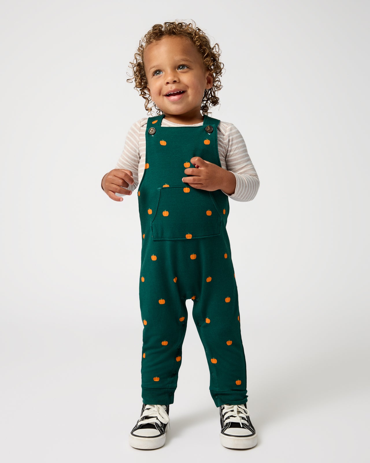 Standing child wearing the Mini Pumpkins Overall Bodysuit Set