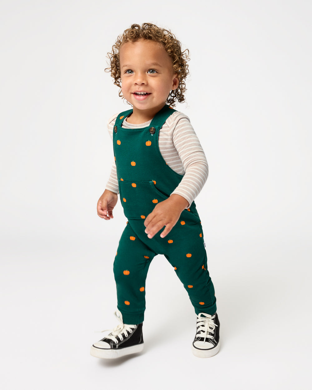 Walking toddler wearing the Mini Pumpkins Overall Bodysuit Set