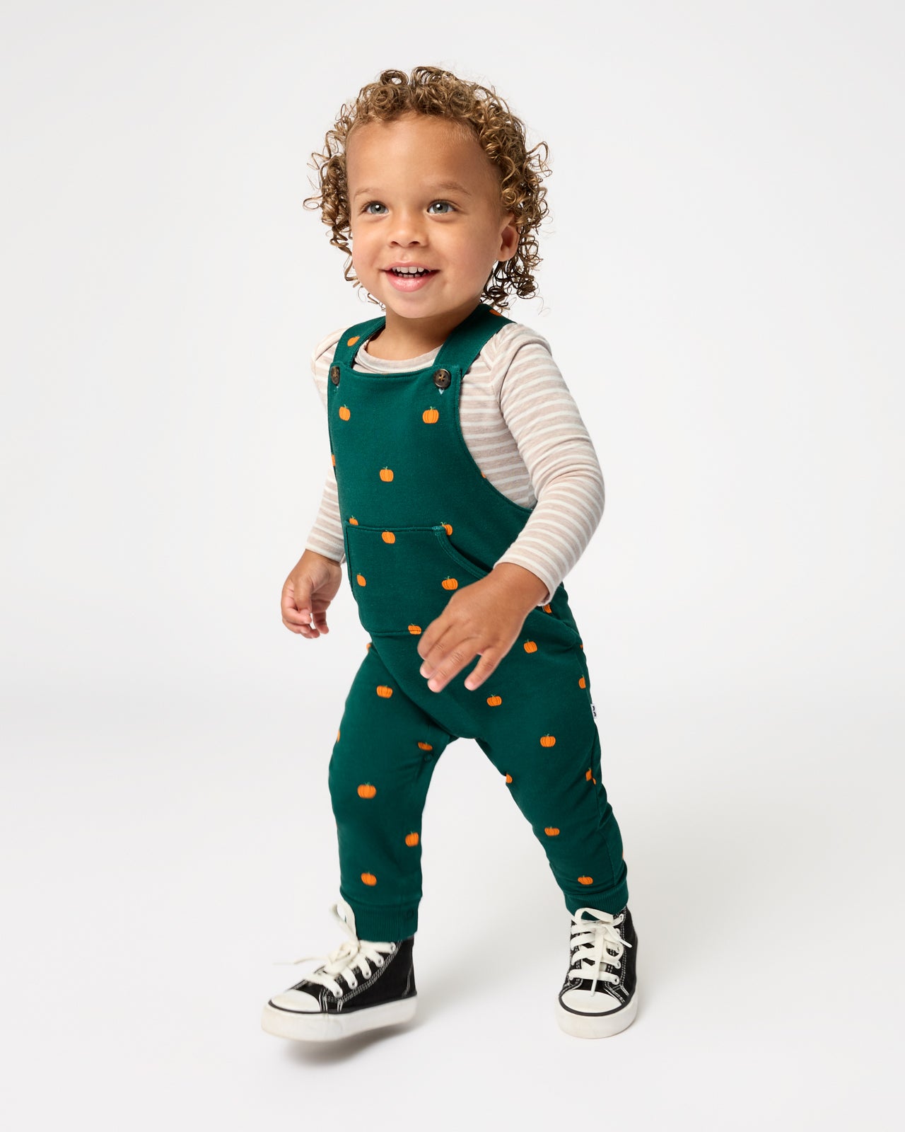Walking toddler wearing the Mini Pumpkins Overall Bodysuit Set