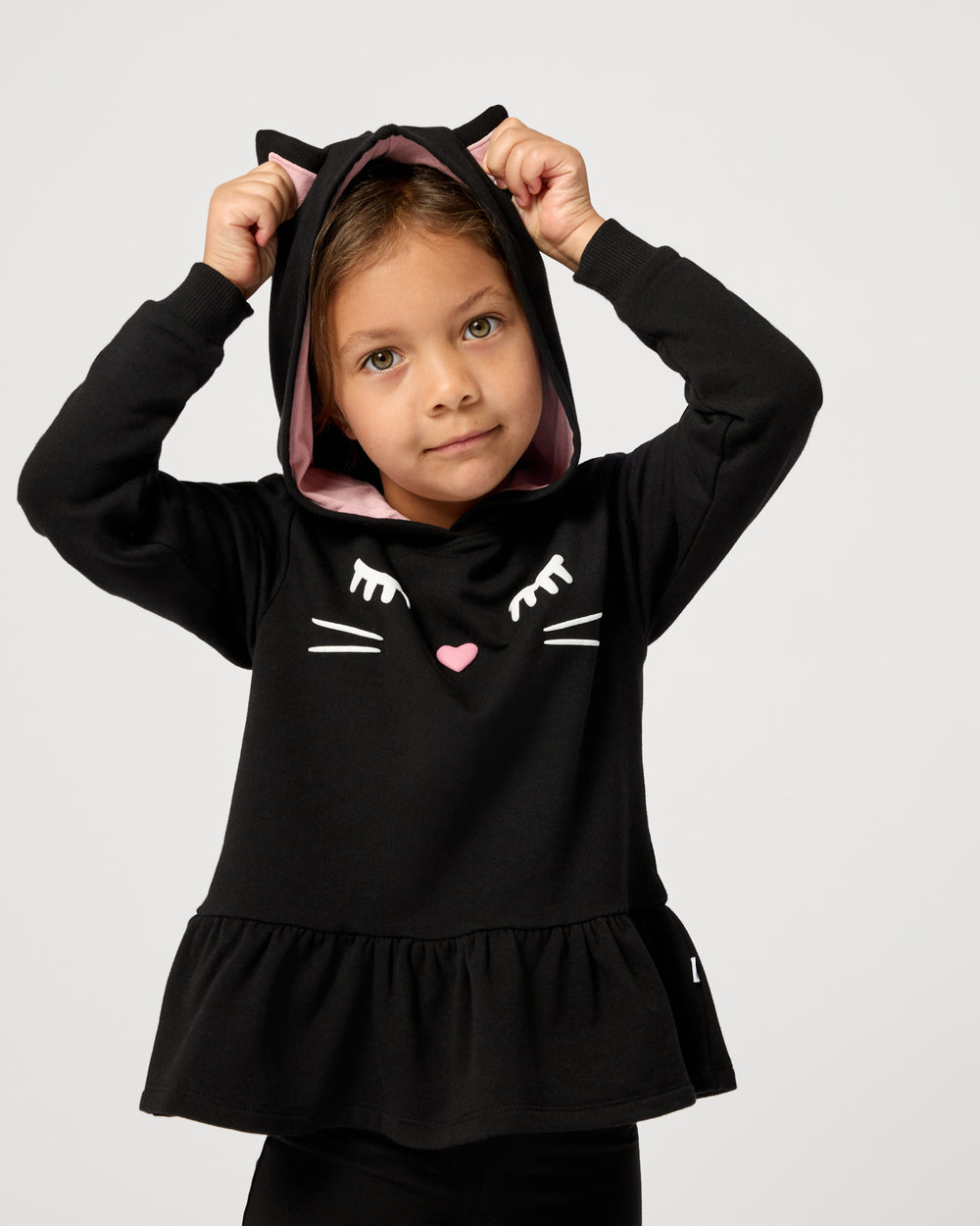 Girl wearing the Black Cat Peplum Hoodie with the hood on