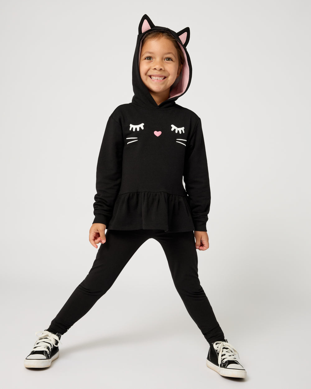 Girl wearing the Black Cat Peplum Hoodie with black leggings