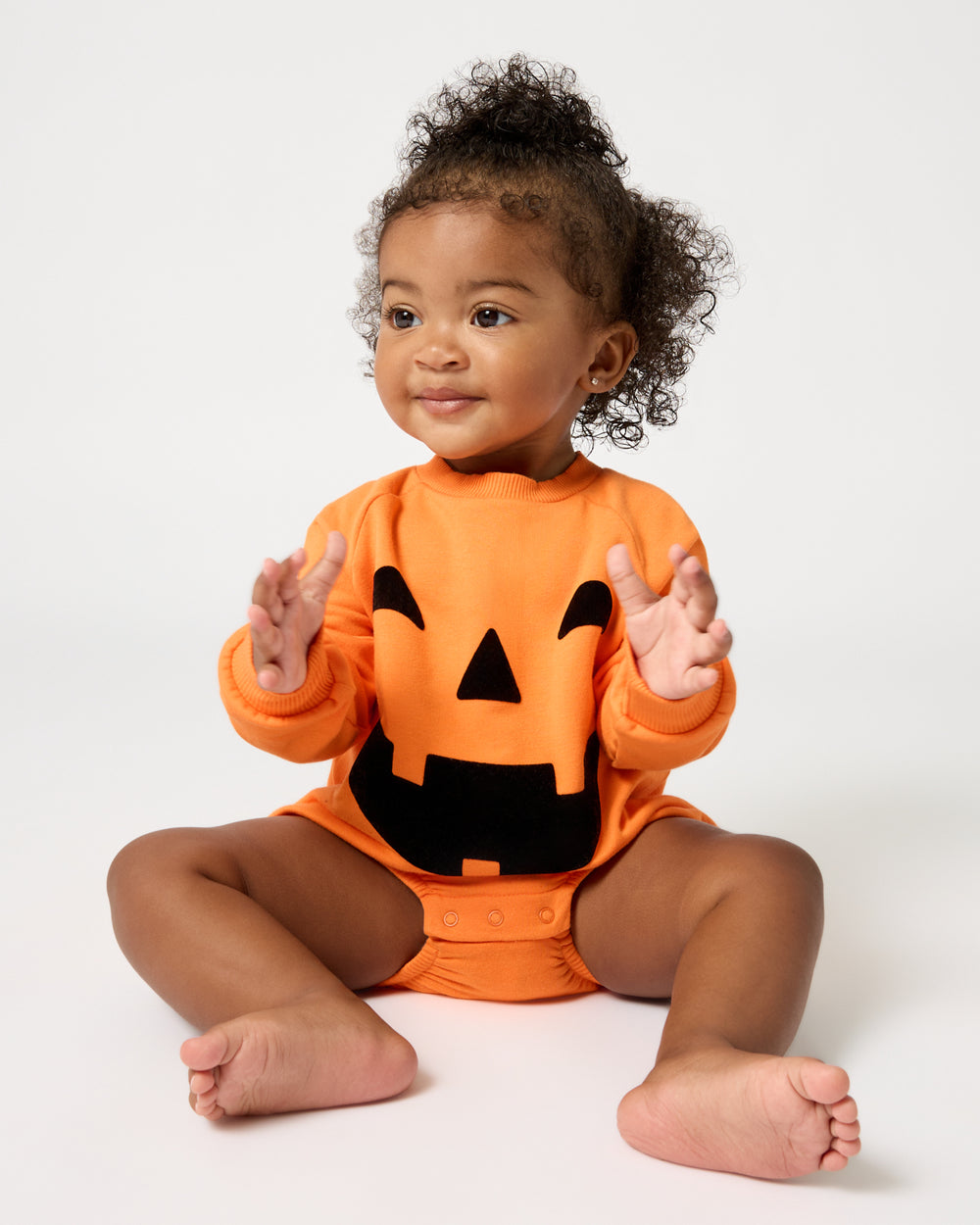 Baby girl wearing the Jack-O'-Lantern Raglan Romper