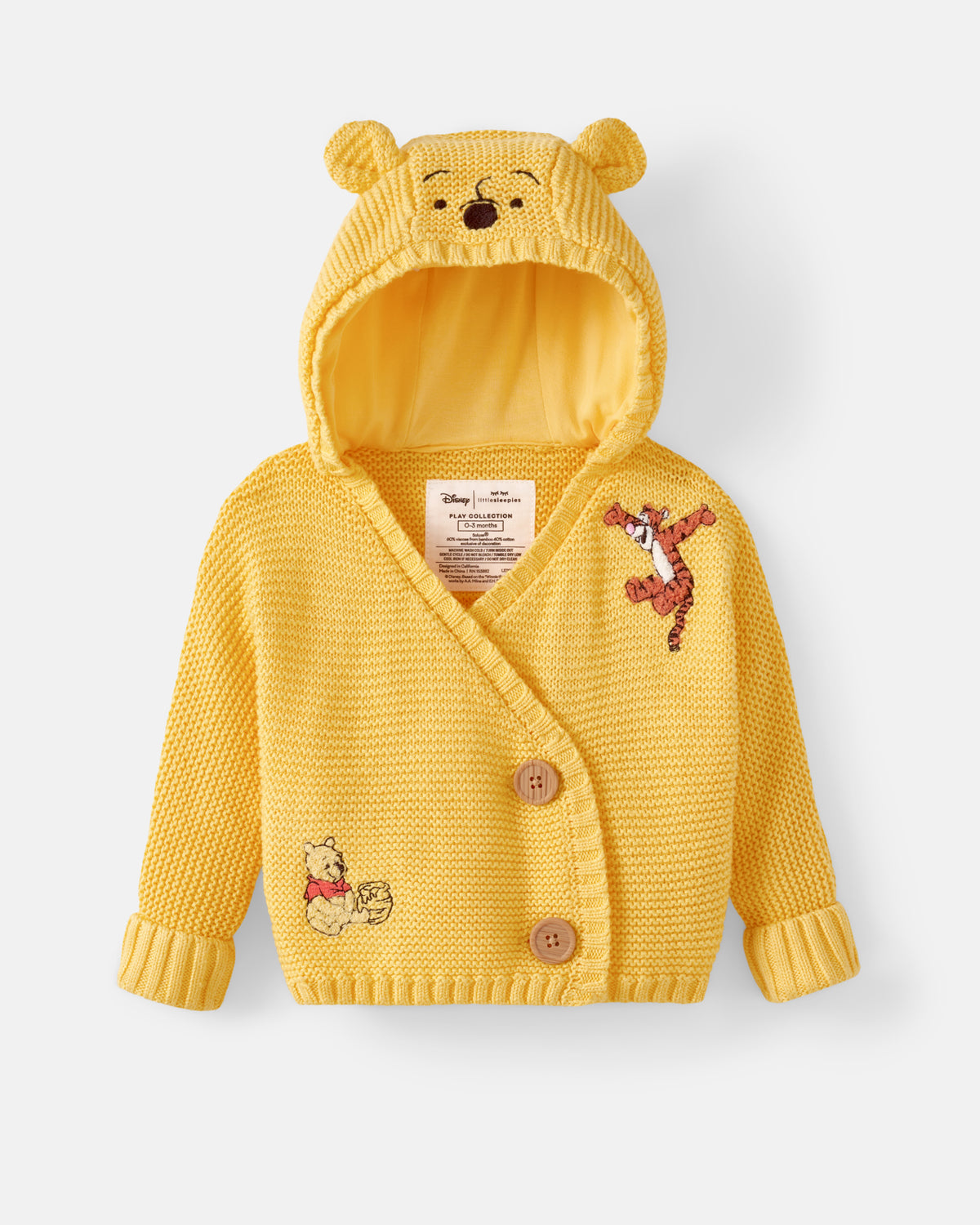 A yellow knit hooded cardigan for babies, featuring Winnie the Pooh and Tigger embroidery, displayed on a light gray background.
