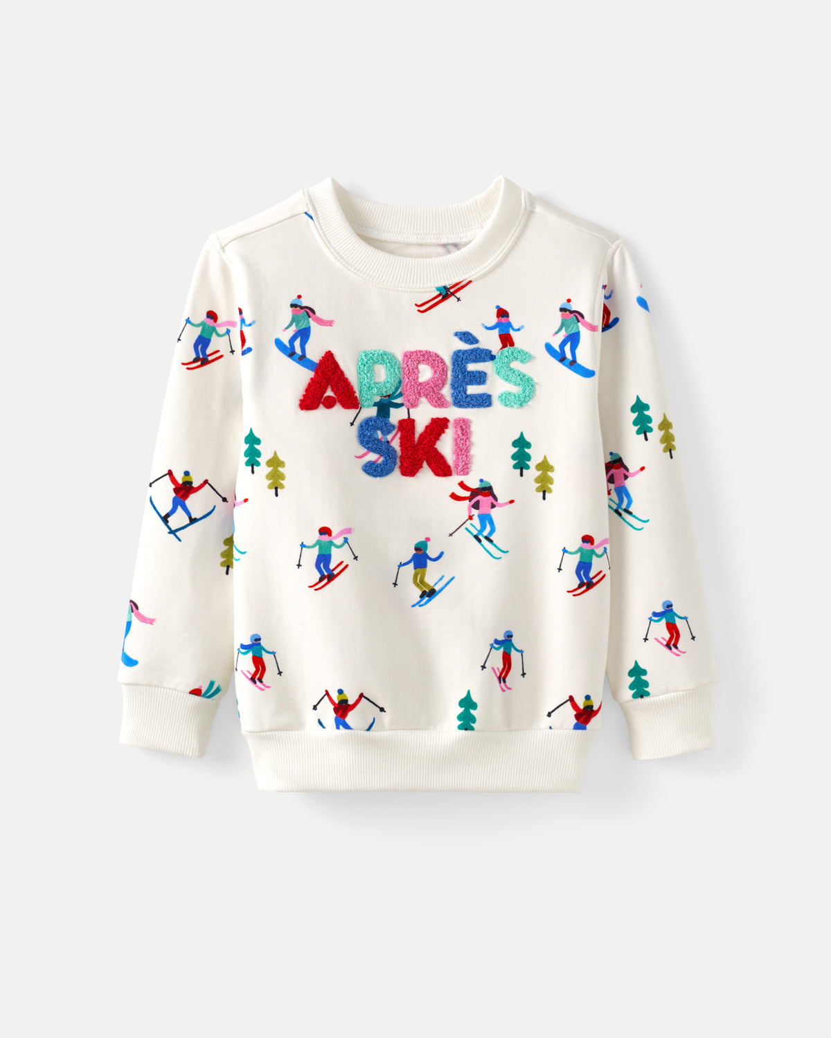 An off-white long-sleeve crewneck sweatshirt featuring a colorful 'APRÈS SKI' text design in the center, surrounded by a playful pattern of skiers and pine trees in various bright colors.