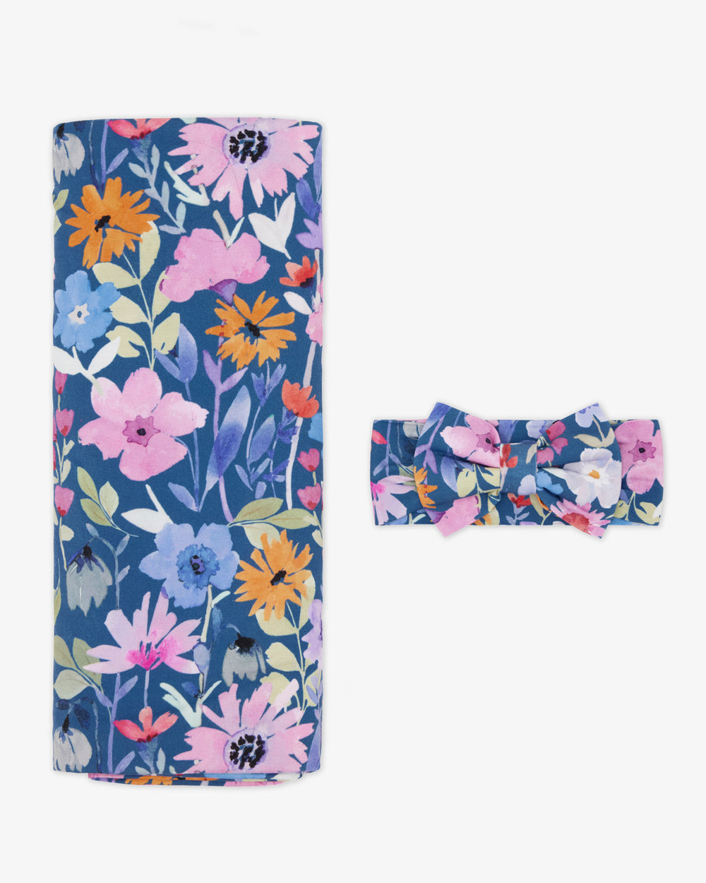 Flat lay of the Dusk Blooms Swaddle & Luxe Bow Headband Set