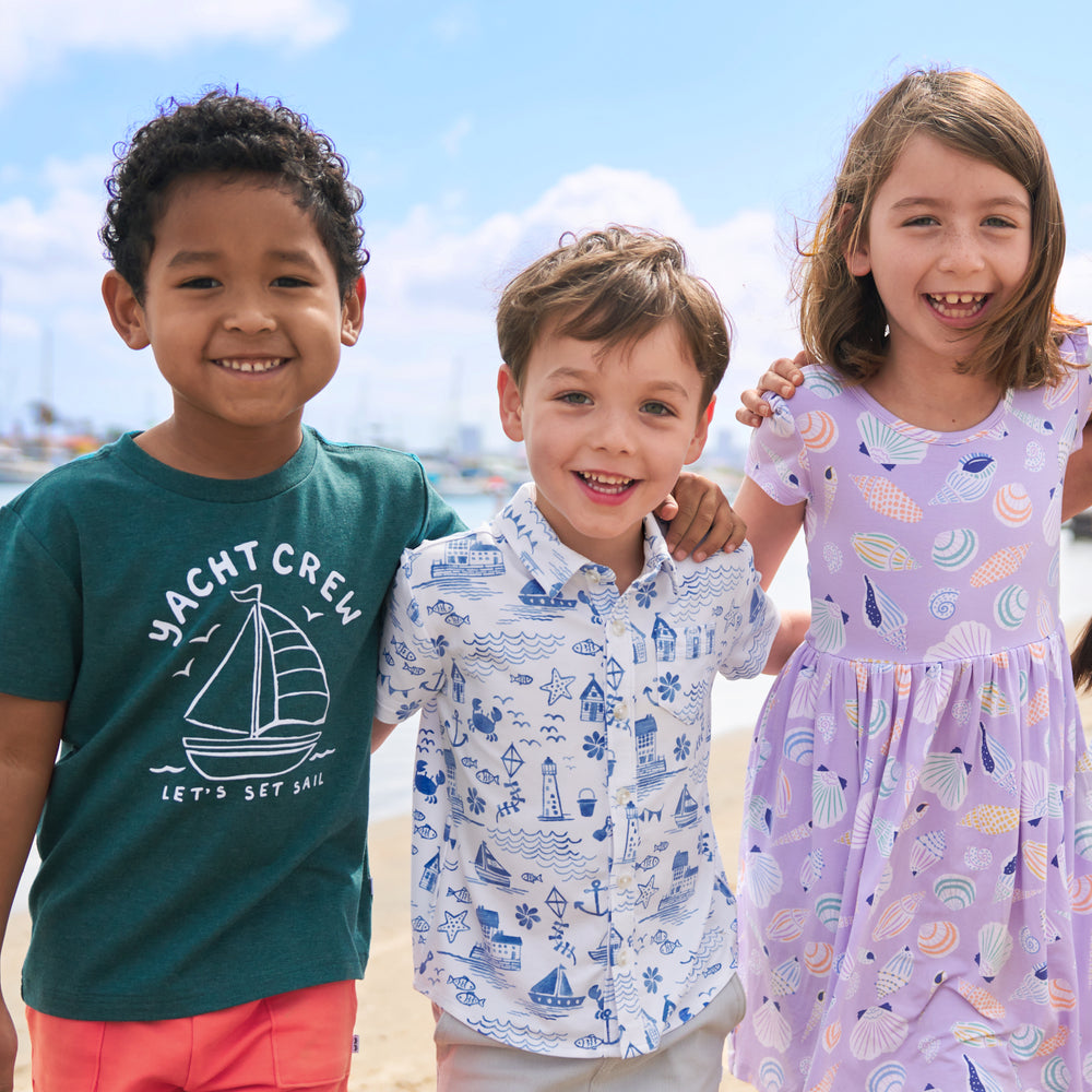 Three children wearing matching play styles from the Coastal Collection