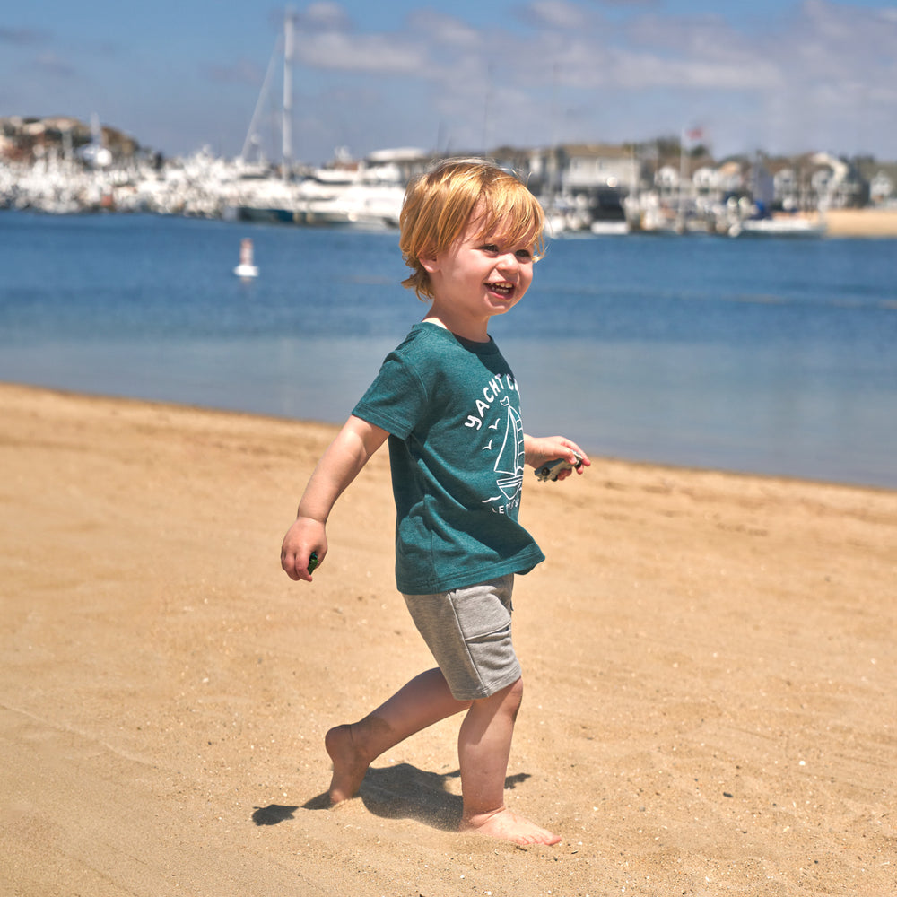 Child walking on the beach wearing the Yacht Crew Short Sleeve Relaxed Tee