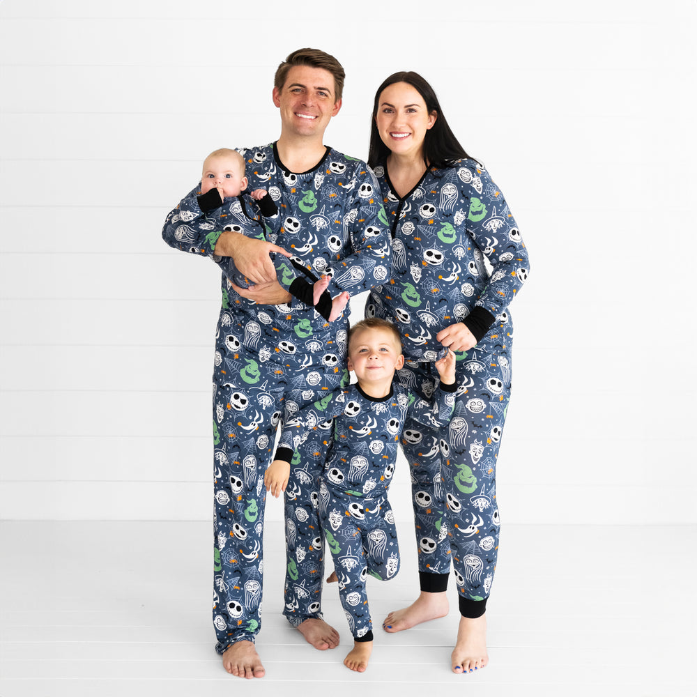 Family of four wearing Disney Jack & Crew printed pajama sets in men's, women's and children's styles. Children are wearing two piece and zippy styles.