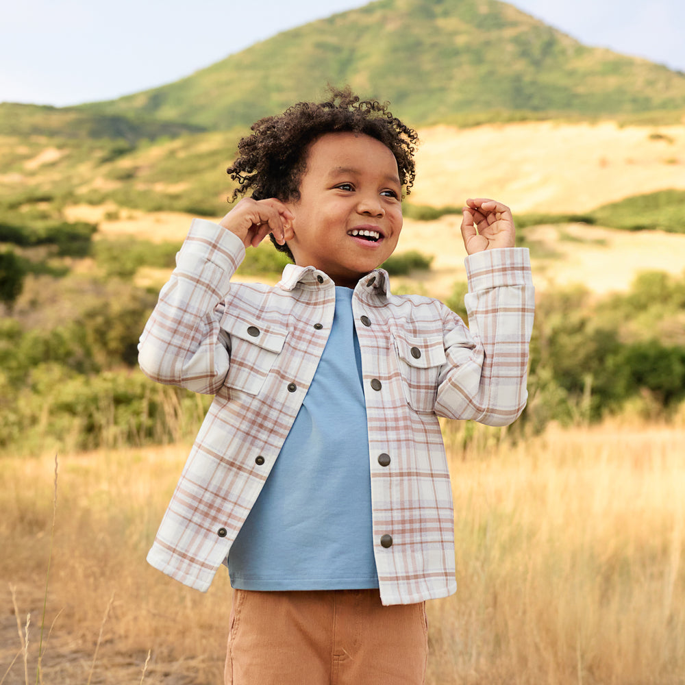 Boy outdoors while wearing the Canyon Plaid Shacket