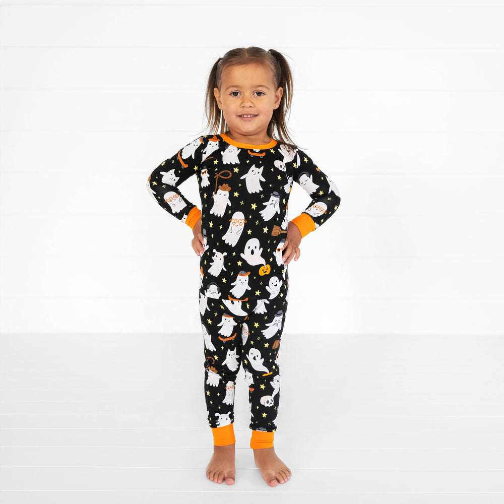 Child posing wearing a Friendly Ghost printed two piece pj set