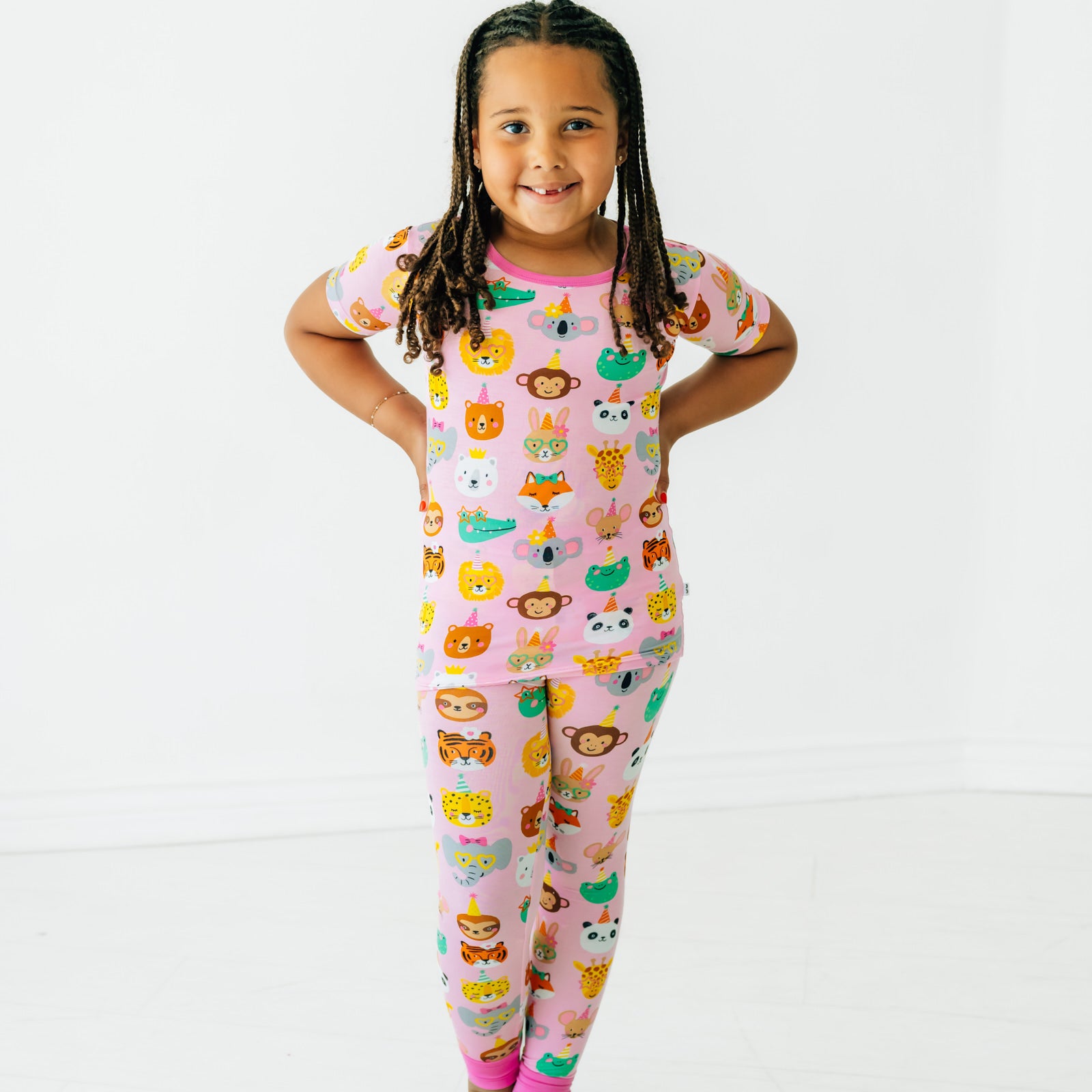 Child posing wearing Pink Party Pals two piece short sleeve pj set