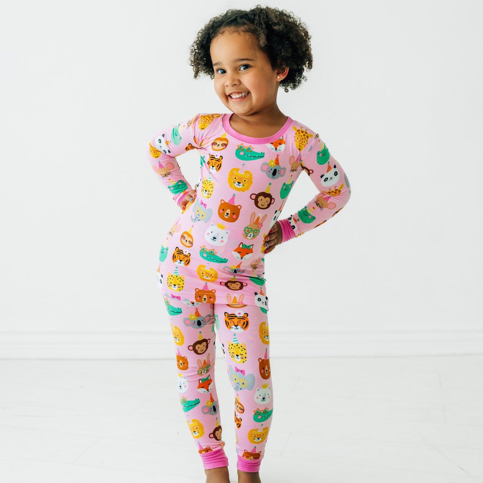 Child posing wearing a Pink Party Pals two piece pj set