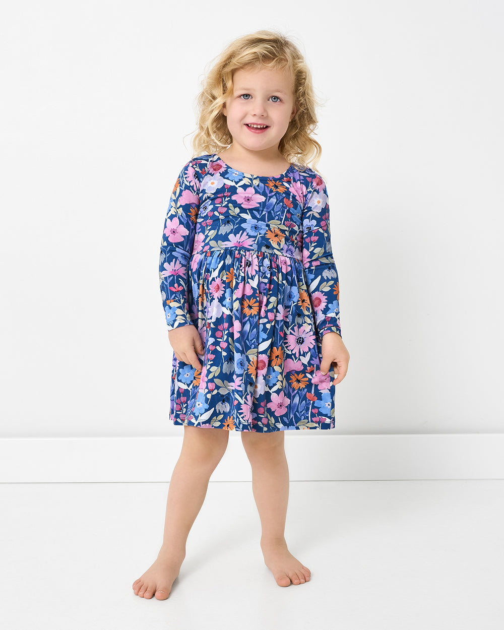 Girl wearing the Dusk Blooms Bow Back Skater Dress