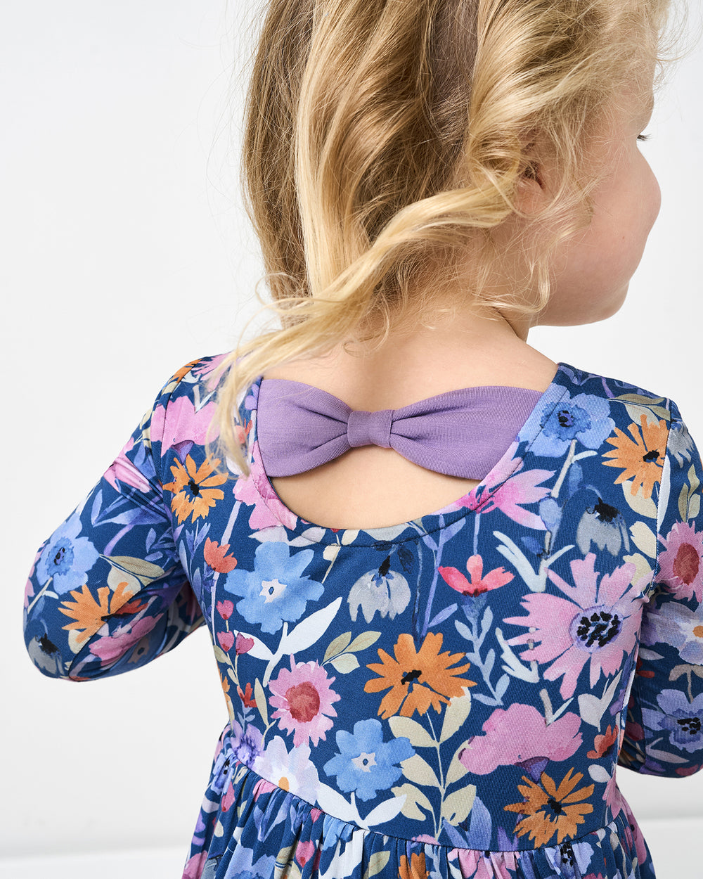 Close up of the bow detail on the Dusk Blooms Bow Back Skater Dress