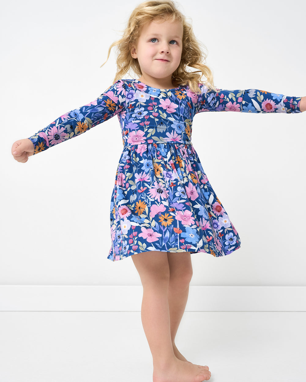 Posing girl wearing the Dusk Blooms Bow Back Skater Dress